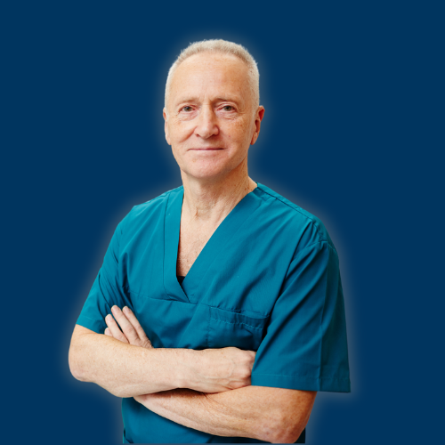 Confident cross-armed dentist in uniform looking at camera on background of medical equipment in his clinics